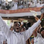 Worshippers raise their hands in thanks to God for the election of John Atta-Mills service at a service at the Pure Fire Miracle Church in Accra on January 4 2009. (AFP)