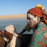 A woman wearing a mussiro mask in Ibo Island, Mozambique. (Flickr/Rosino)