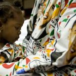 Two-year-old Princess Smith sits with her father Francis Smith as they await Obama's arrival at the International Conference Centre in Accra on July 11 2009. (AFP)