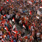 Volunteers form a safe zone between men and women to prevent sexual harassment during a protest against Mohamed Morsi in Cairo on July 3 2013. (AP)
