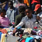 A Kenyan vendor sells second-hand clothes, locally known as 'mitumba', at an open-air market in Nairobi. (Pic: AFP)