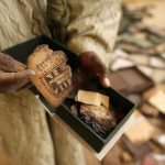 A museum guard displays a burnt ancient manuscript in its box at the Ahmed Baba Centre for Documentation and Research, in Timbuktu. (Pic: Reuters)