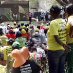 Supporters of Zimbabwe's President Robert Mugabe listen to his televised speech during the official opening ceremony of the first session of Zimbabwe's Parliament in Harare on September 17 2013. (Pic: AFP)