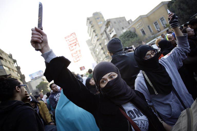 An Egyptian protester holds up a knife during a demonstration to demand an end to sexual violence against women on February 6 2013 in the Egyptian capital of Cairo. (Pic: AFP)