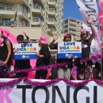 People stand on a float holding signs in reaction to Uganda's law banning homosexuality. Hundreds of people gathered on the streets of Green Point in Cape Town, South Africa, on March 1 2014 to take part in the Gay Pride Parade. (Pic: AFP)