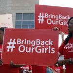 Protesters hold signs during a demonstration on May 6 2014 outside the Nigerian embassy in Washington, DC. (Pic: AFP)