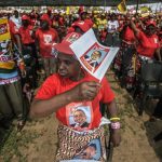Mozambican Liberation Front (FRELIMO) presidential candidate Filipe Nyusi supporters cheer during the FRELIMO
