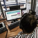 An Zambian HIV counsellor looks at phone text messages coming up on the U-report platform for HIV and Aids awareness at a call centre in Lusaka. (Pic: AFP)