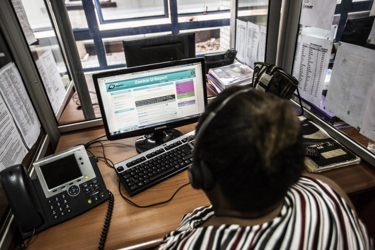 An Zambian HIV counsellor looks at phone text messages coming up on the U-report platform for HIV and Aids awareness at a call centre in Lusaka. (Pic: AFP)