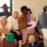 Kazungu Kassim (R), head of a Burundi albino association, listens to proceedings inside a courtroom in Ruyigi, eastern Burundi on May 28 2009. Prosecutors in Burundi asked for life sentences for three people on trial for allegedly murdering albinos to sell their body parts for use in witchcraft. (Pic: Reuters)