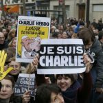 People wave posters featuring Charlie Hebdo cartoons, "Je suis Charlie (I am Charlie)" and "All Charlie" in a Unity rally in Paris on January 11. (Pic: AFP)