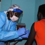 An adhesive bandage is placed on the arm of a volunteer after she was administered an experimental Ebola vaccine at Redemption Hospital in New Kru Town, a suburb of Monrovia, on February 2. (Pic: AFP)