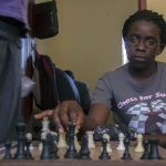 Phiona Mutesi plays a game of chess with her colleagues at the chess academy in Kibuye, Kampala. (Pic: AFP)