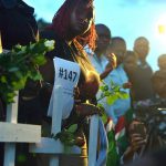 People hold roses and wooden crosses at freedom corner in Uhuru Park during a candlelight vigil in Nairobi on the final day of mourning for the 148 people killed on April 2 by Somalia's al-Shabab Islamists. (Pic: AFP)