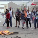 Foreign nationals gesture after clashes broke out between a group of locals and police in Durban on April 14 2015 in ongoing violence against foreign nationals in the city. (Pic: AFP)