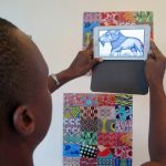 A man tries out Wakpon, a new smartphone application that allows people to view pictures and works of art. (Pic: AFP)