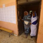 Sudanese women leave after voting at a school turned into a polling station in Al-Jarif West, outside Khartoum, Sudan. Pic: Ashraf Shazly/AFP