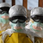 Healthcare workers, wearing protective suits, leave a high-risk area at the French NGO Médecins Sans Frontières Elwa hospital in Monrovia, Liberia. Pic: Dominique Faget/AFP