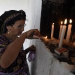 A pilgrim lights a candle inside the mosque. (Pic: AFP)