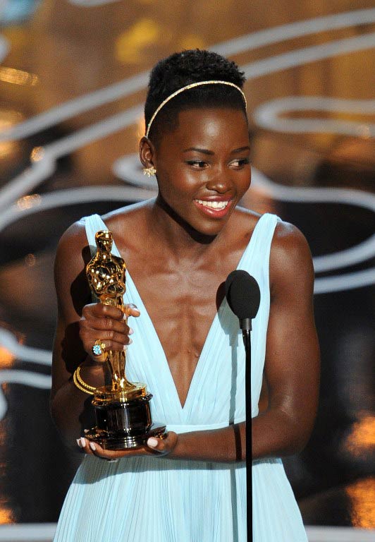 Lupita Nyong'o accepts her best supporting actress Oscar for her role in '12 Years A Slave'. (Pic: AFP)
